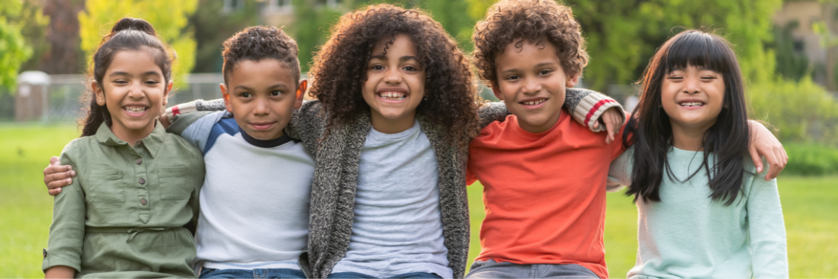 Kids sitting together in a wall formation