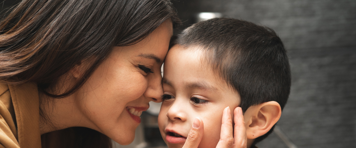 Woman Adoringly Touching A Boy